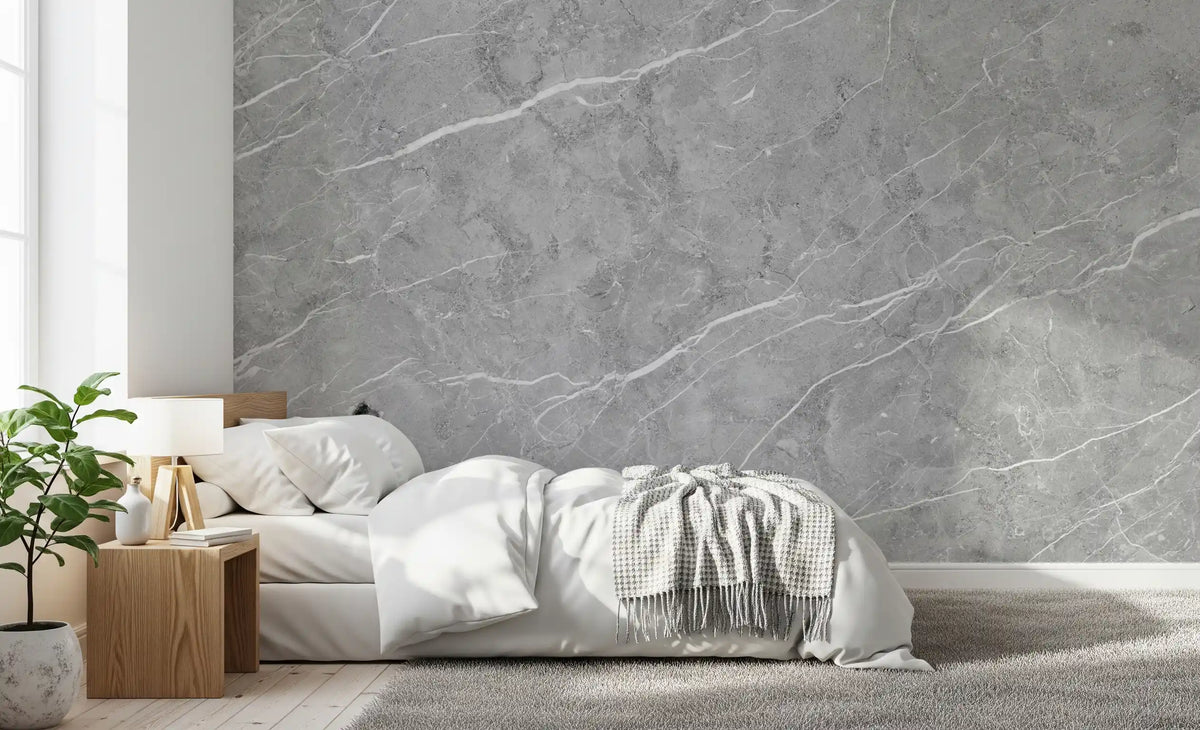 Bedroom with white bedding, checked throw and oak nightstand on gray marble wallpaper GD14081