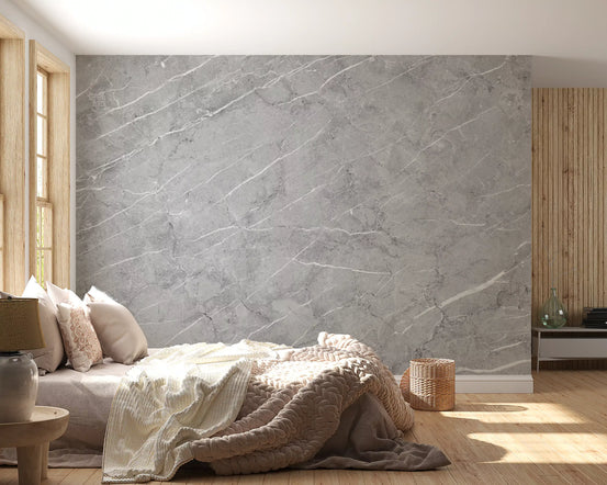 Light gray marble wallpaper behind a bed with knit throw and oak wall slats GD14102