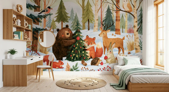 Winter wallpaper mural of forest animals and a Christmas tree beside a wooden desk and kids bed GD14165