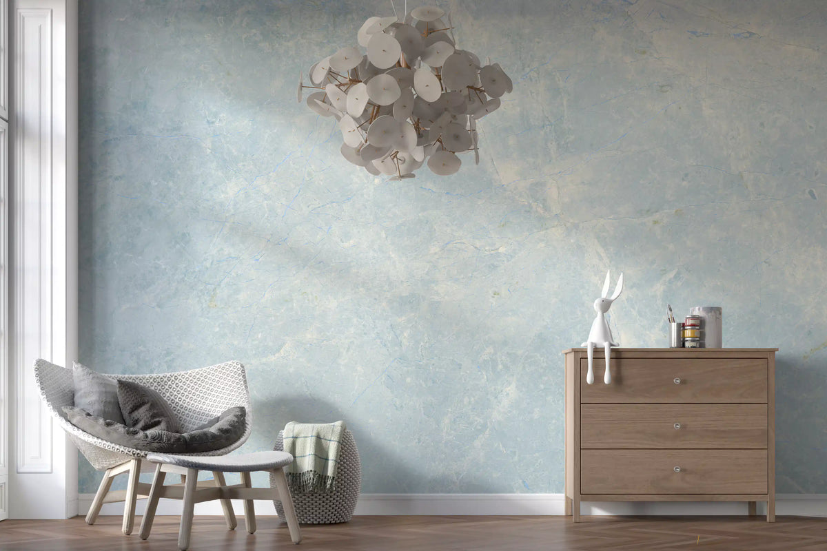 Gray knit armchair, wood dresser and paper pendant against a pale azure stone mural GD14187