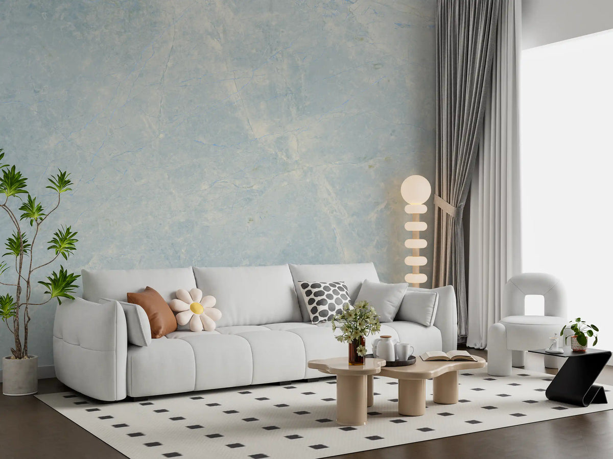 White sofa with flower cushion and checked rug against ethereal marble wallpaper GD14187