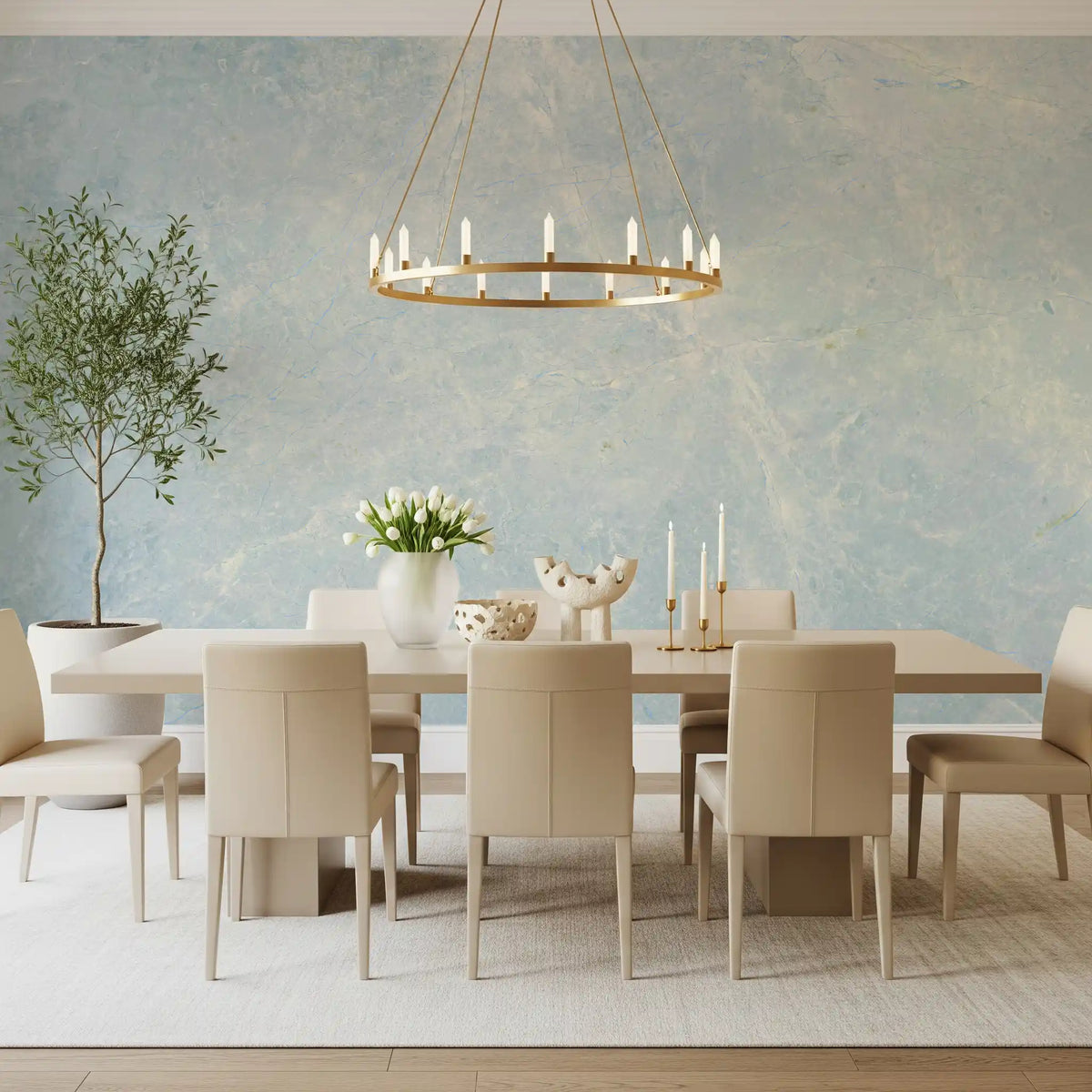 Long dining table with cream chairs and gold ring chandelier on marble wallpaper GD14187