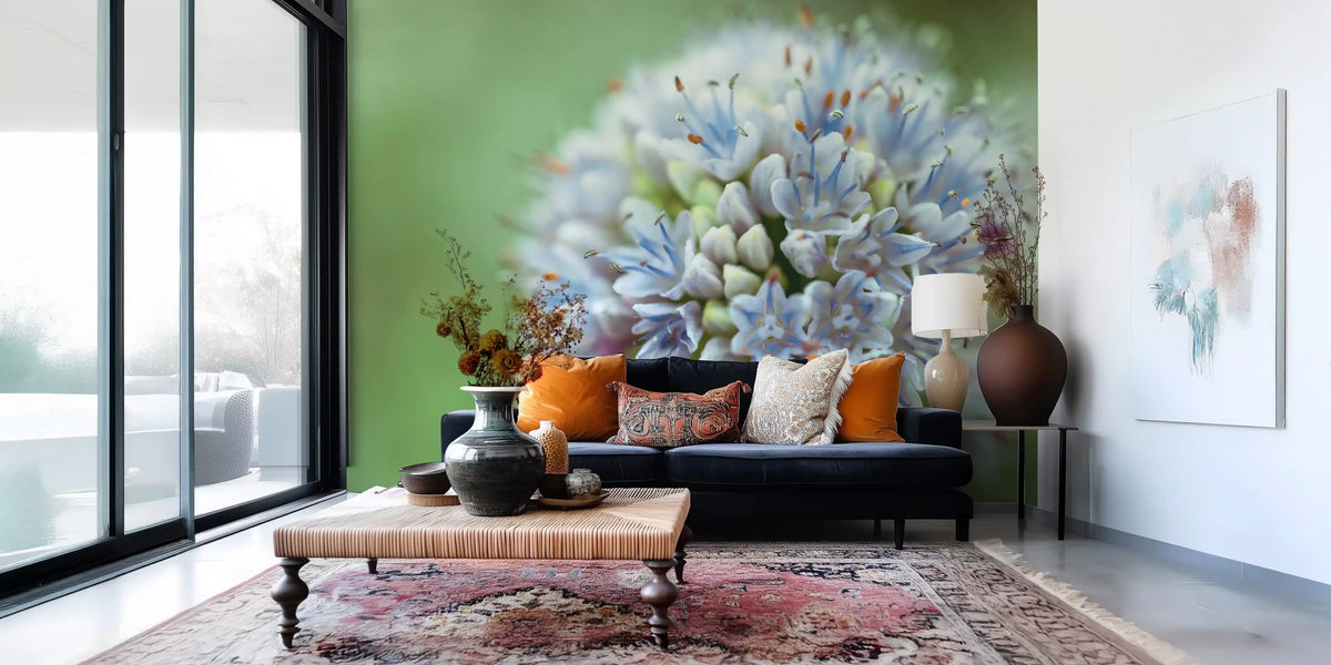 Navy velvet sofa with orange cushions and a Persian rug on allium floral wallpaper GD14202