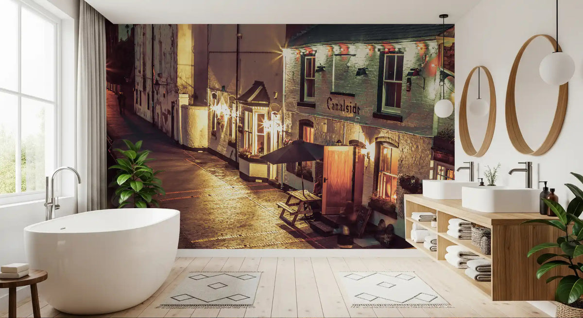 Bathroom with freestanding tub, wood vanity and round mirrors by a canal mural GD14208