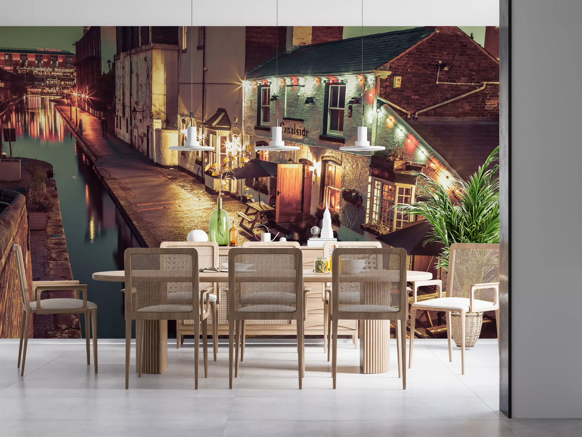 City wallpaper behind a wood dining table with cane chairs and white pendants GD14208
