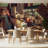 Long dining table with cream chairs and white flowers by a canal pub scene GD14208