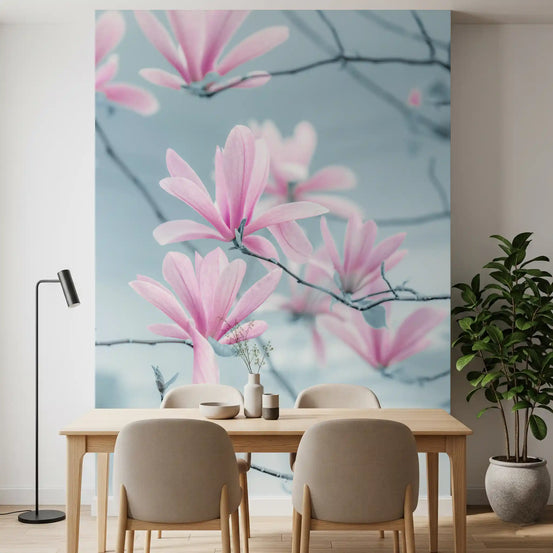 Floral wallpaper behind an oak dining table with beige chairs and a black floor lamp GD14213
