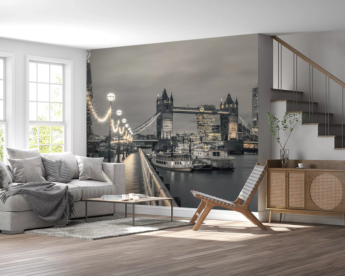 Riverside lights mural behind a gray sofa and sling chair near a wooden staircase GD14214