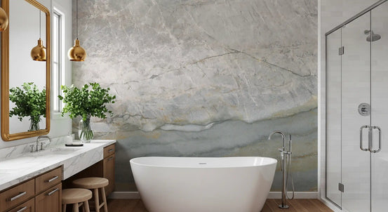 Marble wallpaper behind a freestanding tub and wooden vanity with gold mirror GD14215