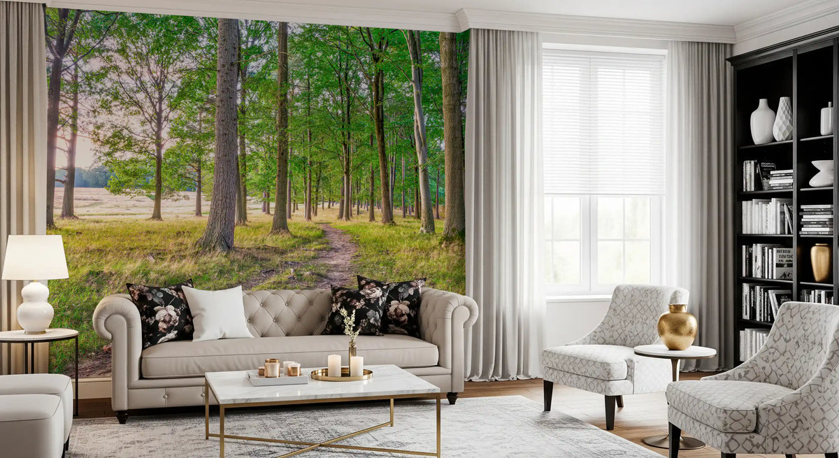 Gray tufted sofa, patterned armchairs and black bookcase in front of forest wallpaper GD14219