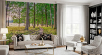 Gray tufted sofa, patterned armchairs and black bookcase in front of forest wallpaper GD14219