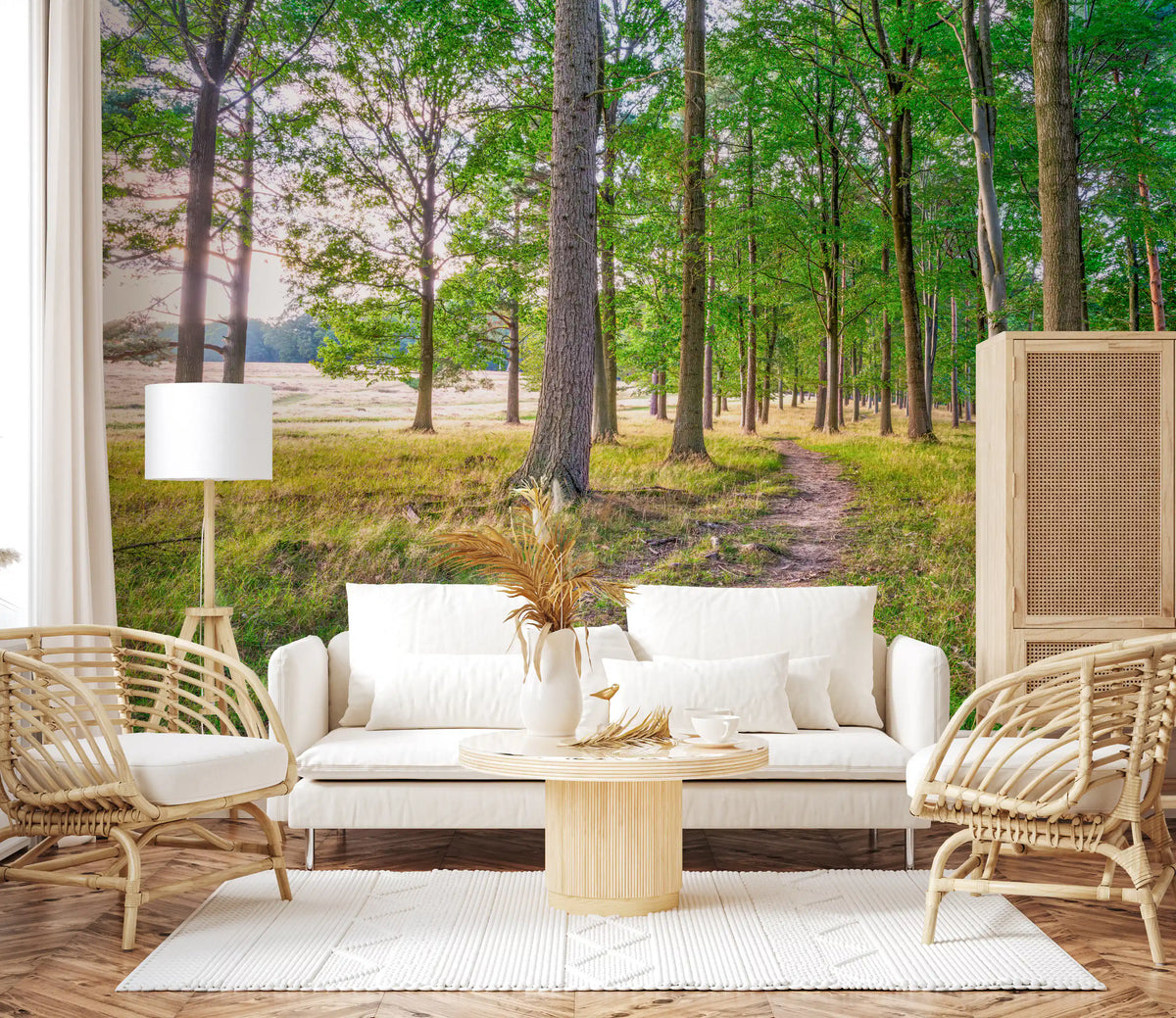 Cream sofa, rattan armchairs and round wood coffee table against a sunlit woodland mural GD14219