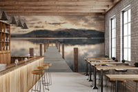 Bar with wooden counter, high stools and brick wall beside lake wallpaper of a jetty at dusk GD14220