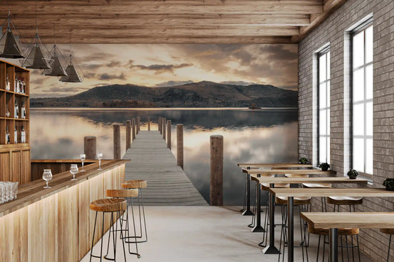 Bar with wooden counter, high stools and brick wall beside lake wallpaper of a jetty at dusk GD14220