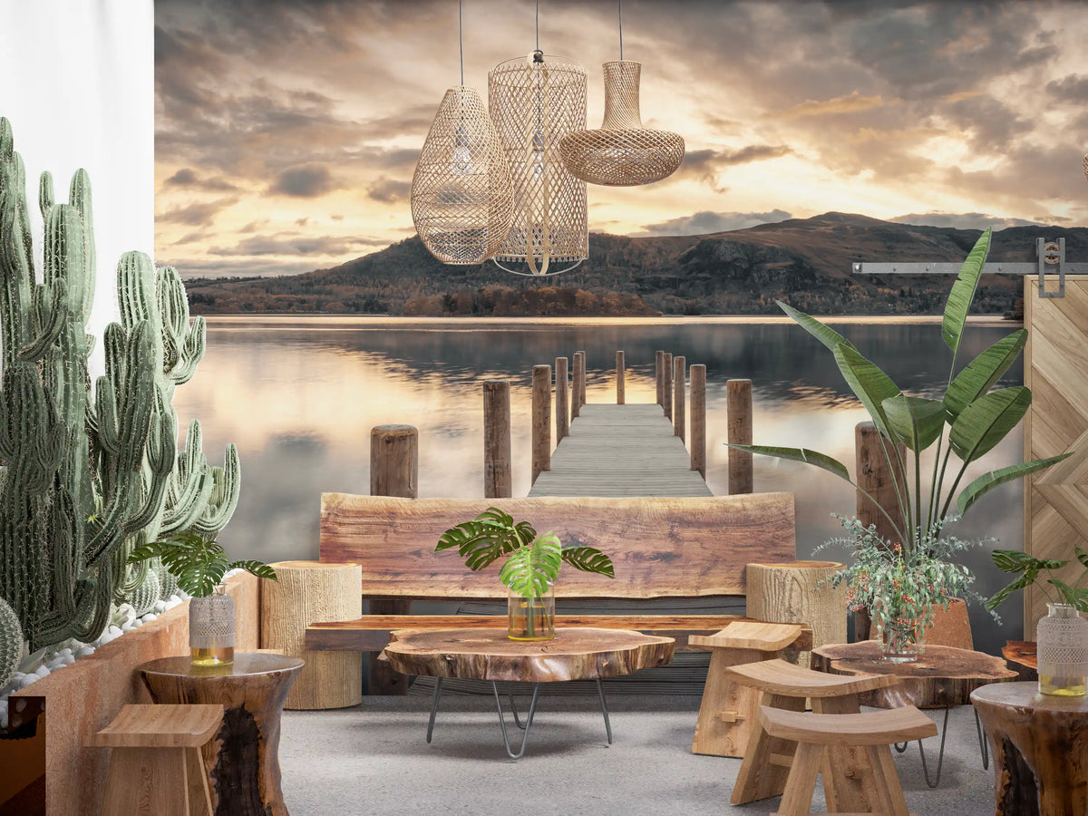 Cafe seating with live edge wood tables, cactus plants and rattan pendants on a lake dusk mural GD14220