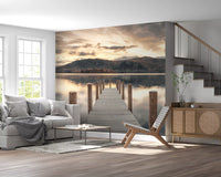 Gray sofa, wooden lounge chair and rattan sideboard by a staircase on a lake jetty wall mural GD14220