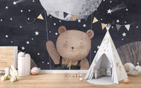 Starry night mural perfect for kids, featuring a bear and balloon.
