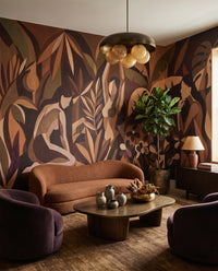 Curved women and monstera move across a Living room in the Amber Veil wall mural.