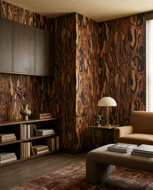 Warm brown burl grain of the Ettore Walnut wall mural settles a quiet Living room.