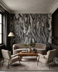 Swirling marbled grain shapes a moody wall mural backdrop for the lounge.