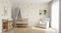 Cream Baby Forest Friends wallpaper behind a wood crib with grey canopy and changing table in a soft nursery