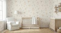 Cream Baby Forest Friends wallpaper of woodland animals behind a natural wood crib and cream nursery glider