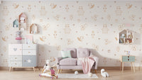 Cream Baby Forest Friends wallpaper with sketched animals above a dusty pink loveseat in a pastel kids room