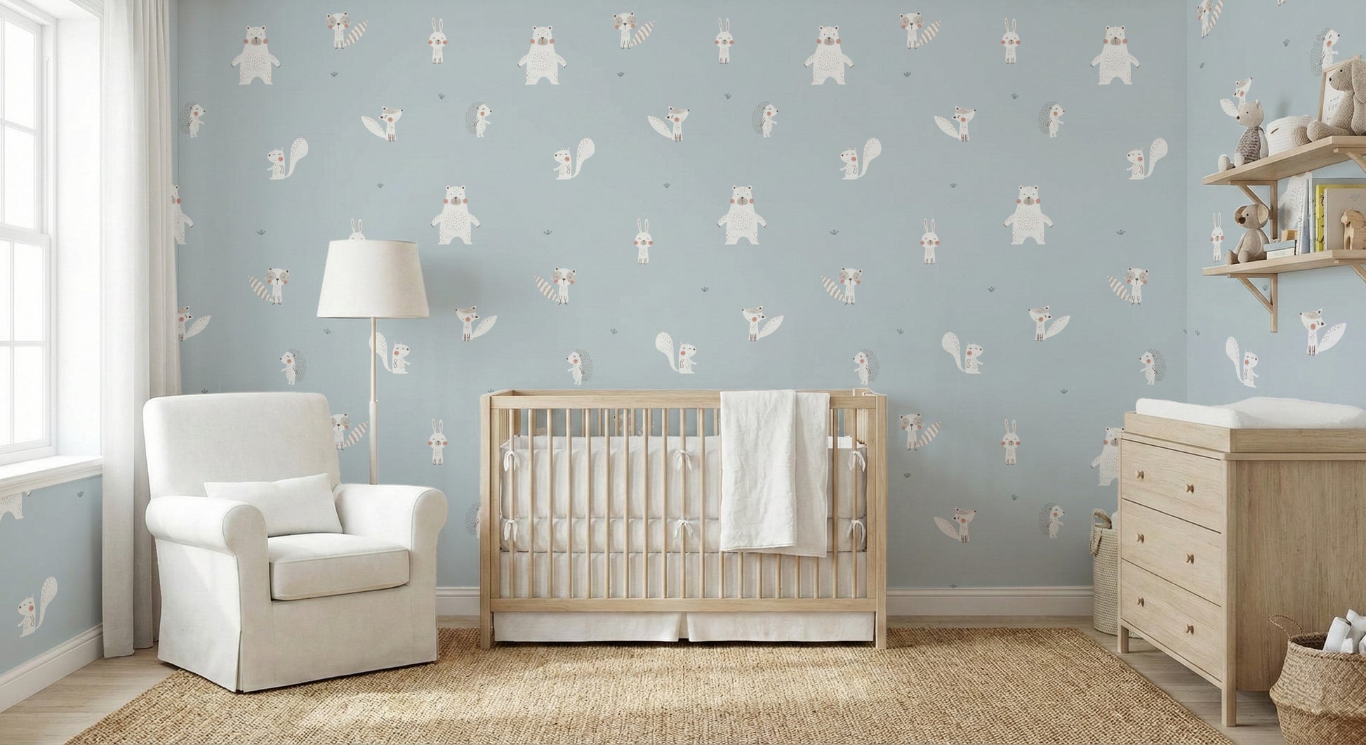 Forest Animals Blue wallpaper behind a pink sofa and white dresser in a playful blue kids room