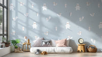 Forest Animals Blue wallpaper of woodland animals above a low white daybed with pink cushions in a blue room