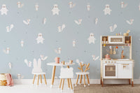 Forest Animals Blue wallpaper shown behind a white play kitchen and animal kids table in a blue playroom