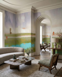 Lounge sitting beside the painterly Velvet Dawn wall mural and turquoise pool tones.