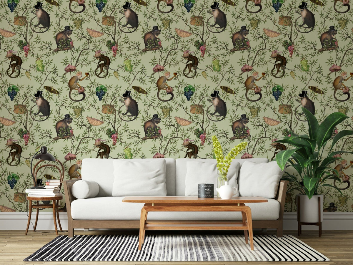 A Primate's Afternoon Tea green wallpaper behind a white wood-frame sofa with a striped rug and plant