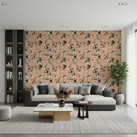 A Primate's Garden Party pink wallpaper behind a grey sectional sofa and tall black bookshelf