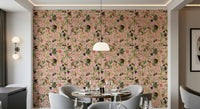 A Primate's Garden Party pink wallpaper with top-hat monkeys behind a round dining table and grey chairs