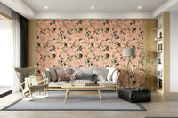 A Primate's Garden Party wallpaper of pink florals and monkeys behind a grey sofa and wood rocking chair