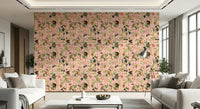 A Primate's Garden Party pink wallpaper shown full-wall between two white sofas in a bright living room