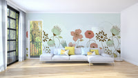 Abstract Flower wallpaper mural of peach and sage blooms on pale mint behind a grey sectional sofa