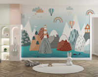 Abstract Mountain with Sea wallpaper in pastel teal with rainbows above a round rug and bunny toys in a nursery