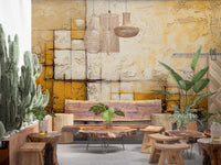 Abstract Texture wallpaper mural of mustard and ivory textured squares above a live-edge wood bench and cacti in a lounge area