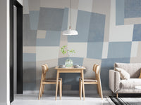 Abstract Cubist wallpaper mural of blue and grey blocks in a dining nook with wooden table and chairs