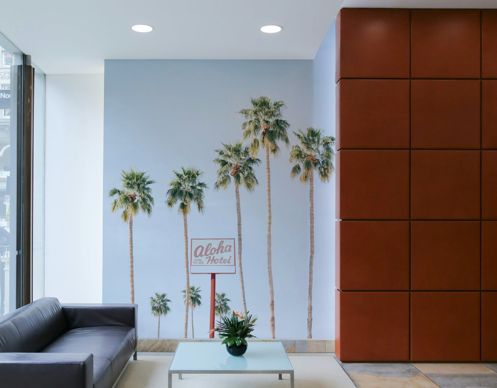 Hawaiian hotel-themed mural with ocean backdrop

