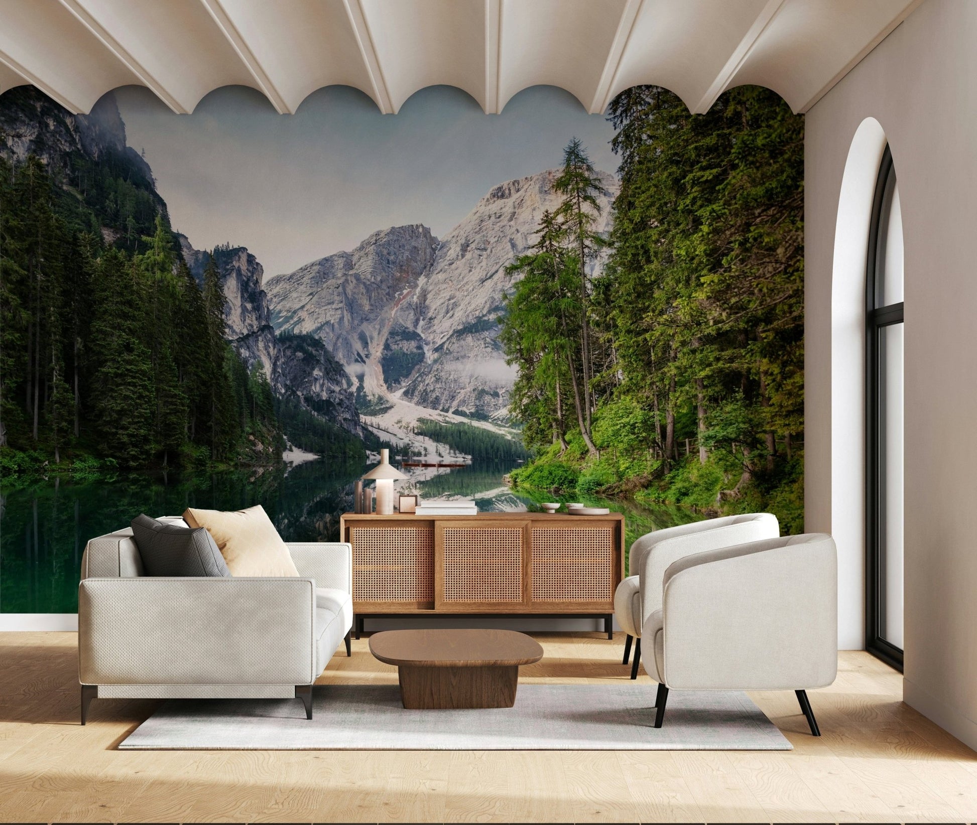 Alpine Reflections wallpaper mural of the lake and Dolomite peaks behind two white armchairs and a cane sideboard