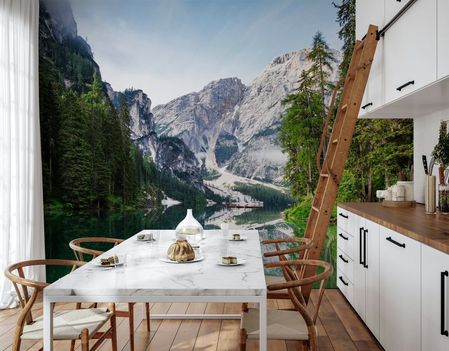 Alpine Reflections wallpaper mural of the mountain lake beside a white marble dining table in a wood-accented kitchen