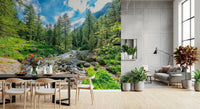Alpine Stream wallpaper mural of a green forest stream behind a dark dining table in an open living and dining room