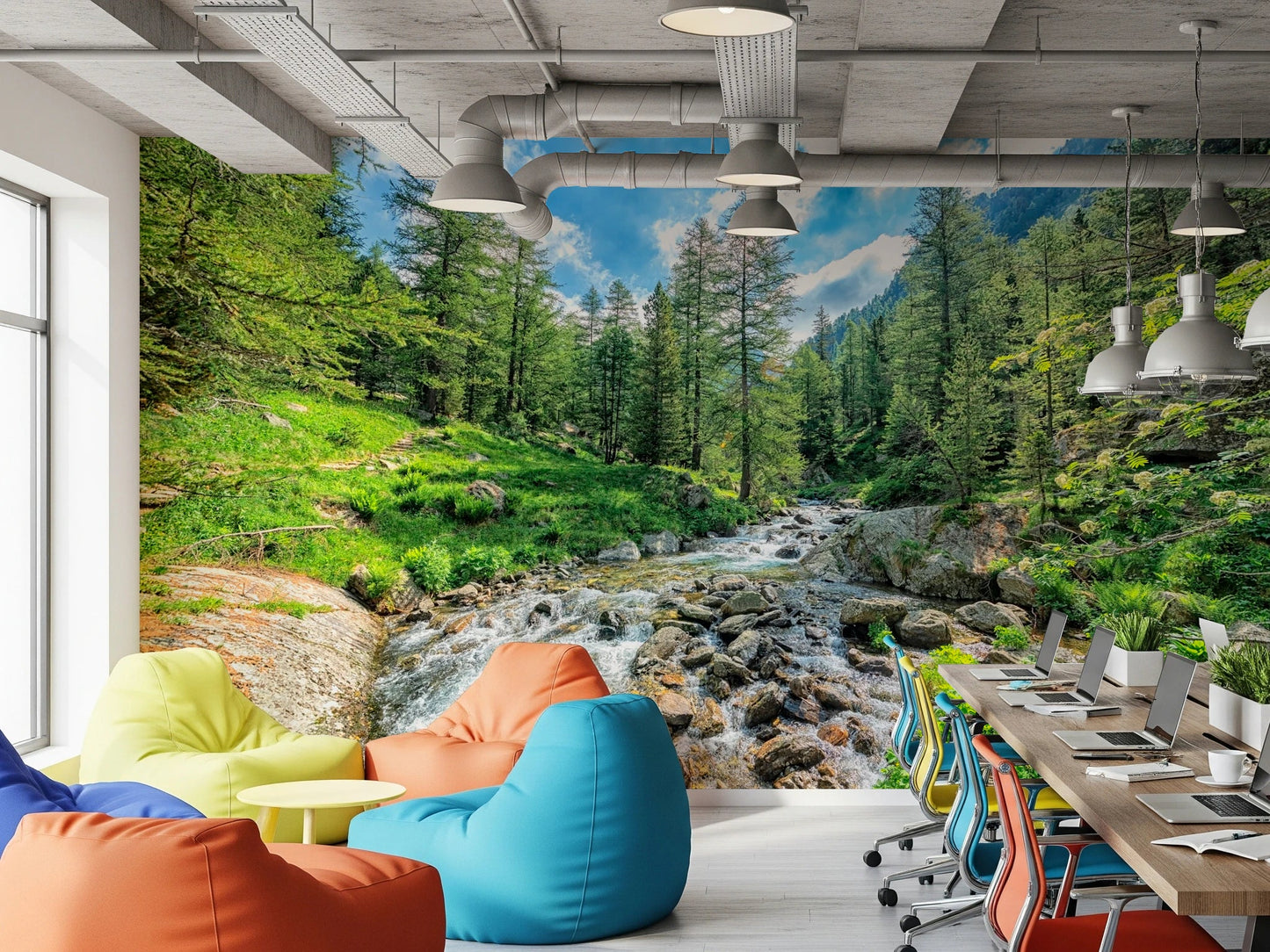 Alpine Stream wallpaper mural with a green forest stream behind colorful bean bags in a home office