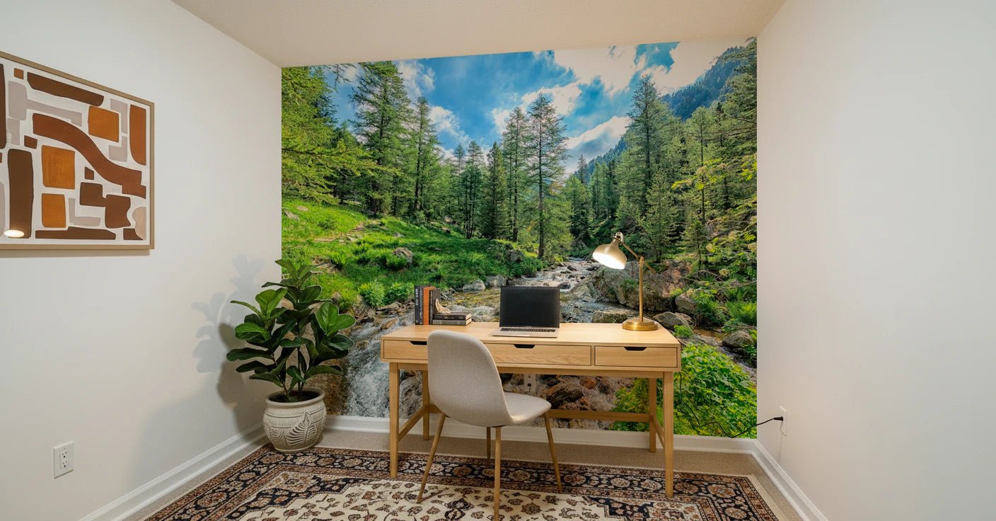 Alpine Stream wallpaper mural with a green forest stream behind a wood desk and chair in a home office