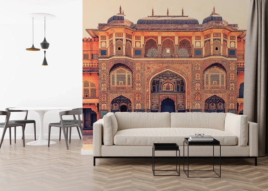 Amber Palace Grandeur wallpaper mural of a terracotta palace with frescoed arches behind a cream sofa and white tulip table
