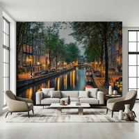 Amsterdam Canal Lights wallpaper mural of an evening canal behind a white sofa and two beige armchairs in a living room