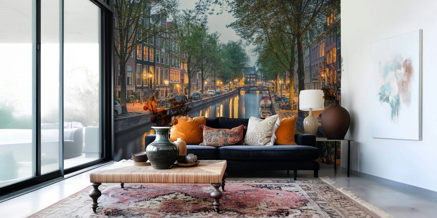 Amsterdam Canal Lights wallpaper mural of a lamplit canal behind a navy blue sofa in a bright living room