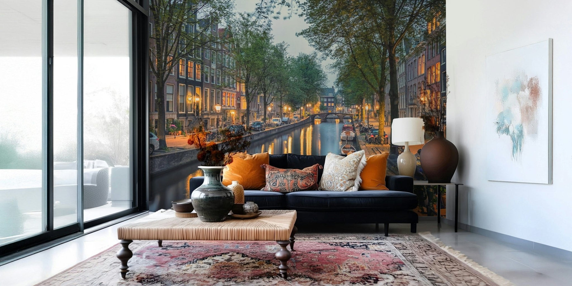 Amsterdam Canal Lights wallpaper mural of a lamplit canal behind a navy blue sofa in a bright living room